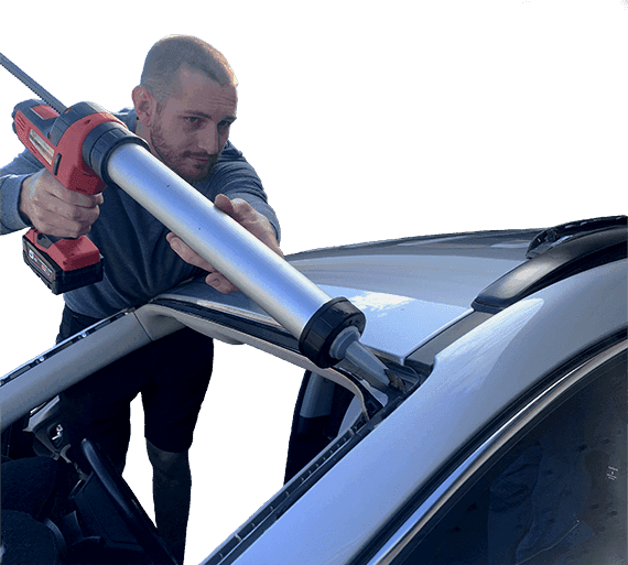 Arby applying adhesive to a windscreen frame