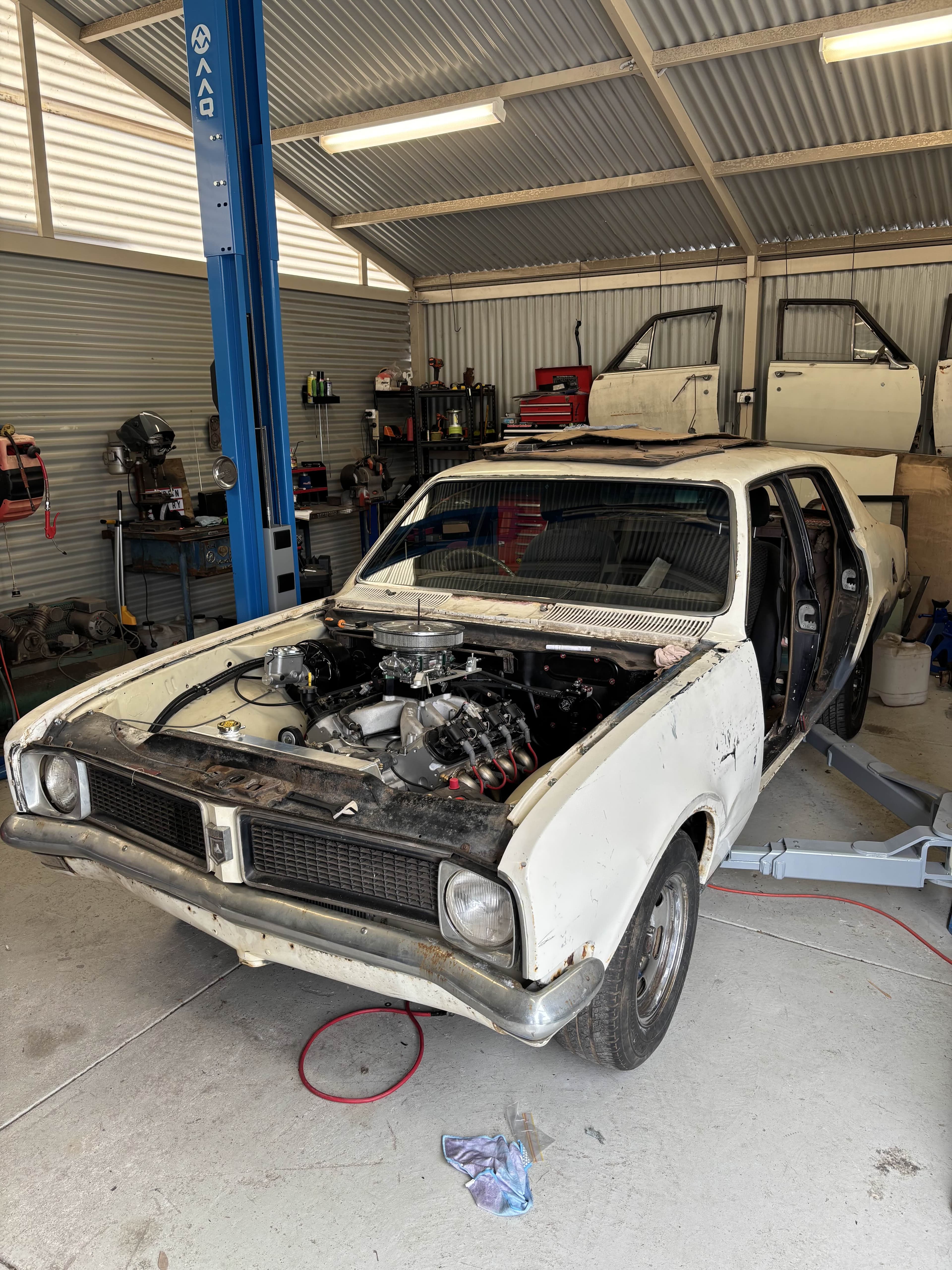 Classic Holden in the workshop with its glass removed